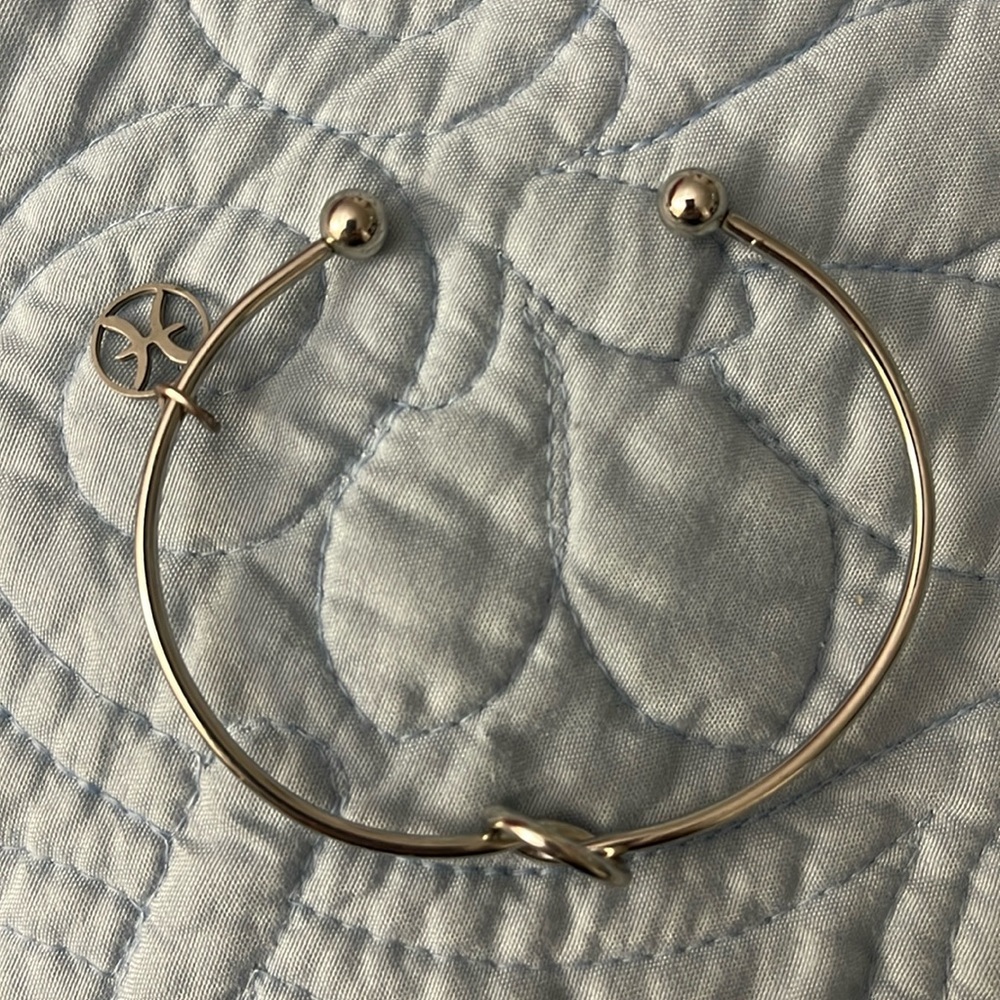 Silver Pisces knot bracelet.